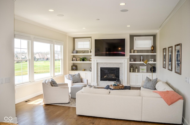 987 Oak Terrace Rd, Westfield, IN 46074 - living area featuring crown molding, wood finished floors, healthy amount of natural light, baseboards, and built in shelves