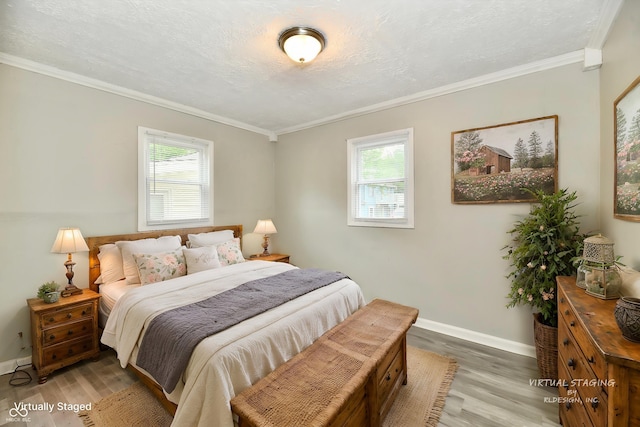 1730 N Graham Ave, Indianapolis, IN 46218 - bedroom featuring multiple windows, light wood-style flooring, ornamental molding, and baseboards