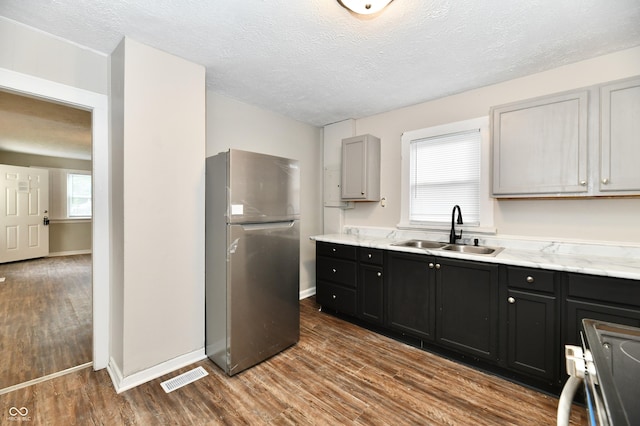 1730 N Graham Ave, Indianapolis, IN 46218 - kitchen featuring freestanding refrigerator, a sink, electric stove, dark wood finished floors, and a textured ceiling