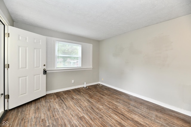 1730 N Graham Ave, Indianapolis, IN 46218 - empty room with wood finished floors, baseboards, and a textured ceiling