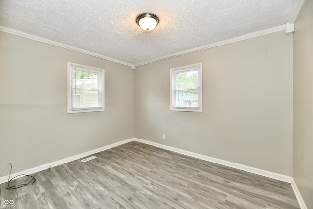 1730 N Graham Ave, Indianapolis, IN 46218 - unfurnished room featuring healthy amount of natural light, wood finished floors, a textured ceiling, baseboards, and ornamental molding