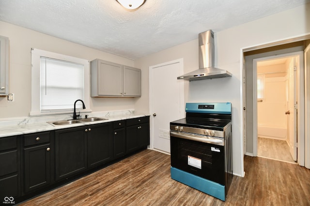 1730 N Graham Ave, Indianapolis, IN 46218 - kitchen with wall chimney range hood, stainless steel electric range oven, a sink, dark wood-type flooring, and a textured ceiling