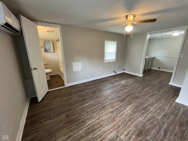1730 N Graham Ave, Indianapolis, IN 46218 - unfurnished bedroom featuring a wall mounted AC, dark wood-type flooring, ensuite bathroom, and a ceiling fan