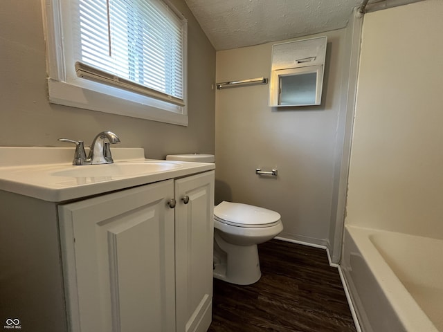 1730 N Graham Ave, Indianapolis, IN 46218 - full bath featuring wood finished floors, vanity, a bathtub, and a textured ceiling