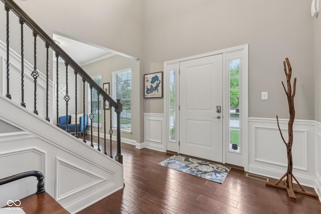 11844 Pine Meadow Cir, Fishers, IN 46037 - entryway with stairway, wainscoting, dark wood finished floors, a decorative wall, and a towering ceiling