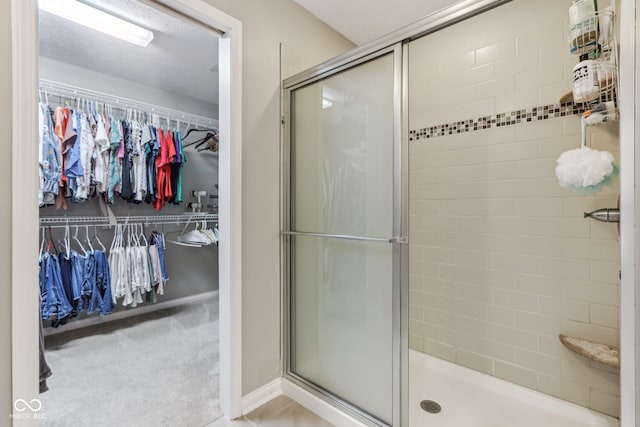11844 Pine Meadow Cir, Fishers, IN 46037 - bathroom with a shower stall and a walk in closet