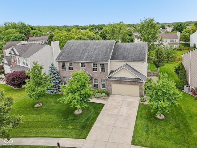 11844 Pine Meadow Cir, Fishers, IN 46037 - colonial inspired home with cooling unit, brick siding, driveway, a chimney, and a front yard