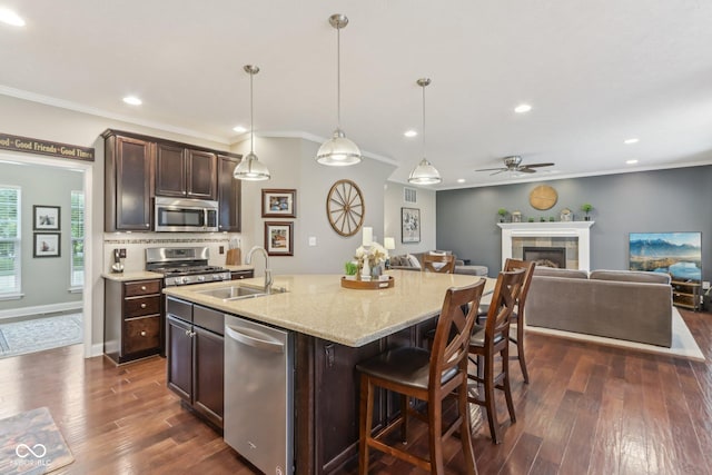 11844 Pine Meadow Cir, Fishers, IN 46037 - kitchen featuring stainless steel appliances, a sink, a ceiling fan, dark brown cabinetry, and dark wood-style flooring