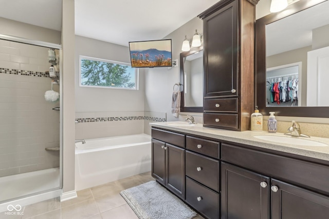 11844 Pine Meadow Cir, Fishers, IN 46037 - bathroom with tile patterned floors, double vanity, a garden tub, and a stall shower