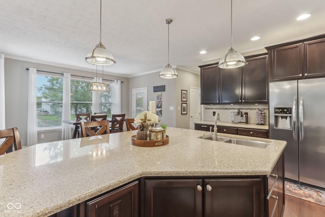 11844 Pine Meadow Cir, Fishers, IN 46037 - kitchen with stainless steel fridge, a sink, dark brown cabinets, recessed lighting, and decorative light fixtures