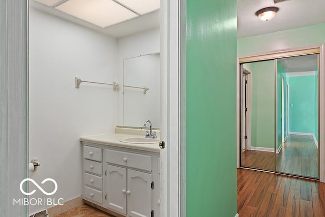 813 Boulder Rd, Indianapolis, IN 46217 - bathroom with vanity, wood finished floors, and baseboards
