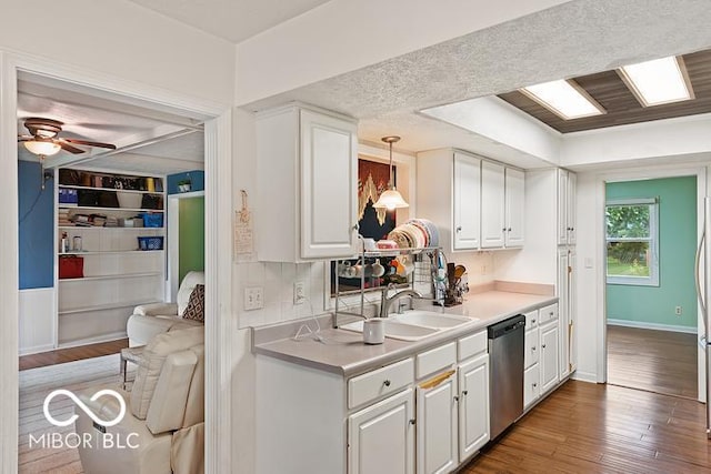 813 Boulder Rd, Indianapolis, IN 46217 - kitchen with dishwasher, white cabinetry, a sink, and light countertops