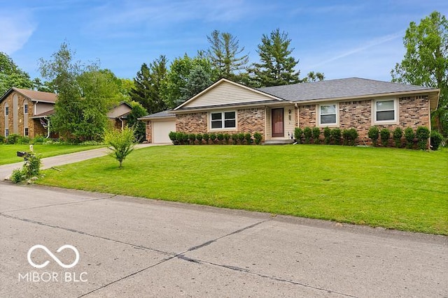 813 Boulder Rd, Indianapolis, IN 46217 - view of front of house featuring a front yard, driveway, brick siding, and an attached garage