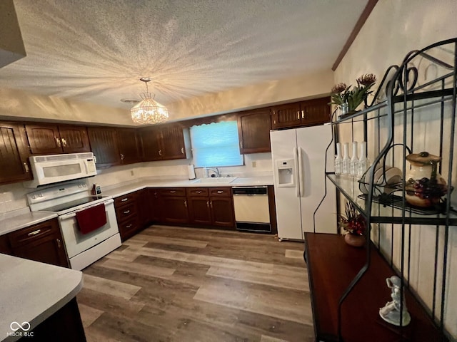 619 W 350 N, Covington, IN 47932 - kitchen with white appliances, a sink, a chandelier, dark wood-style floors, and light countertops