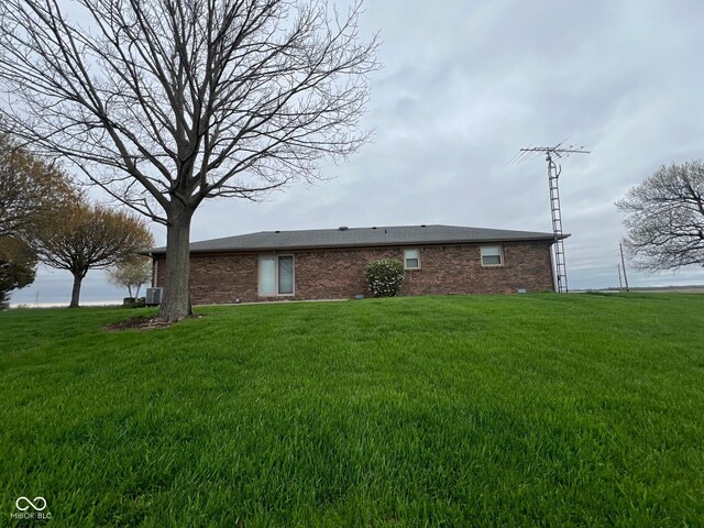 619 W 350 N, Covington, IN 47932 - back of property with brick siding, a yard, and central AC