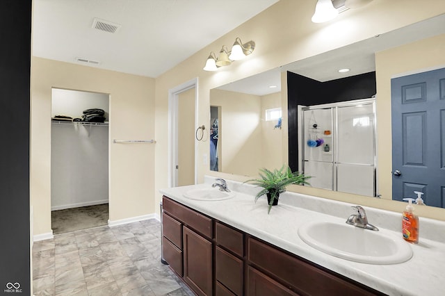 442 Mozart Dr, Greenfield, IN 46140 - full bath featuring a stall shower, double vanity, a spacious closet, and baseboards