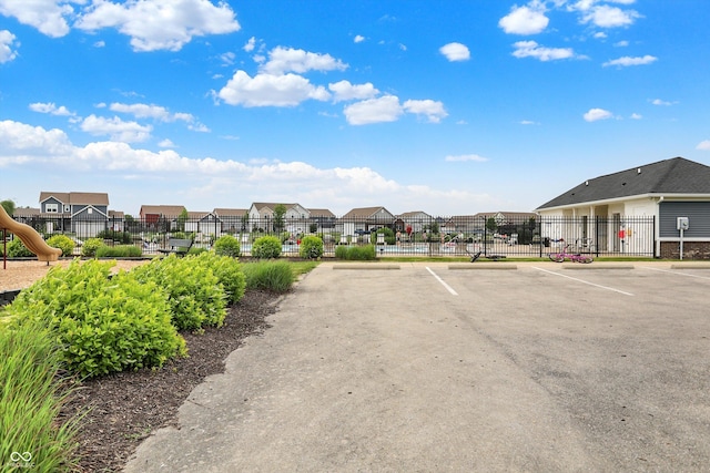 442 Mozart Dr, Greenfield, IN 46140 - uncovered parking lot featuring a residential view and a gate