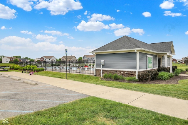 442 Mozart Dr, Greenfield, IN 46140 - view of home's exterior featuring a residential view, a shingled roof, and uncovered parking