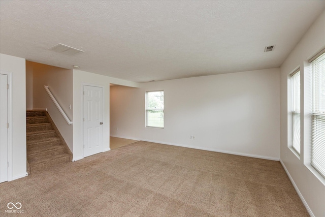 163 Clear Branch Dr, Brownsburg, IN 46112 - carpeted empty room featuring stairway, baseboards, and a textured ceiling
