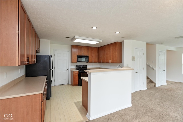 163 Clear Branch Dr, Brownsburg, IN 46112 - kitchen featuring black appliances, brown cabinets, light countertops, a peninsula, and recessed lighting