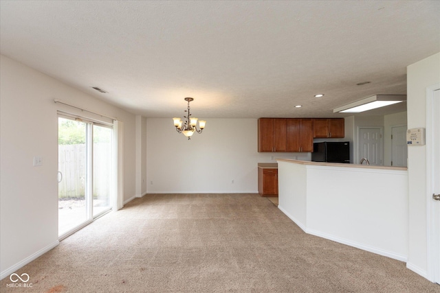 163 Clear Branch Dr, Brownsburg, IN 46112 - unfurnished living room featuring light colored carpet, a chandelier, baseboards, and recessed lighting