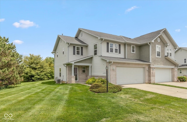 163 Clear Branch Dr, Brownsburg, IN 46112 - view of front facade with brick siding, concrete driveway, a garage, a front lawn, and a shingled roof