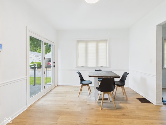 201 N 11th St, Elwood, IN 46036 - dining room featuring light wood-style flooring, wainscoting, and a decorative wall