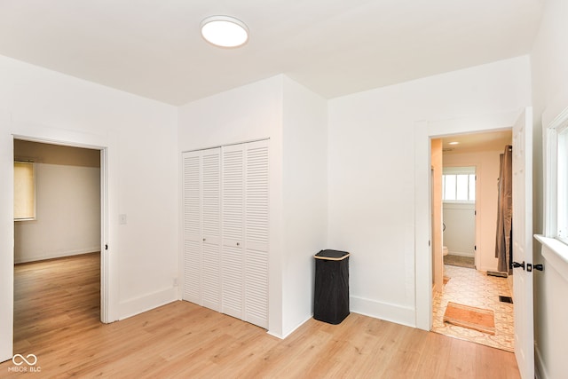 201 N 11th St, Elwood, IN 46036 - unfurnished bedroom featuring light wood-style flooring, a closet, and baseboards
