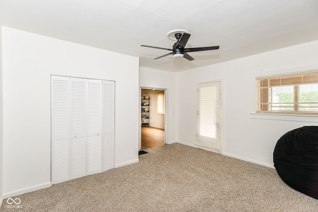 201 N 11th St, Elwood, IN 46036 - unfurnished bedroom featuring carpet flooring, a closet, baseboards, and a ceiling fan
