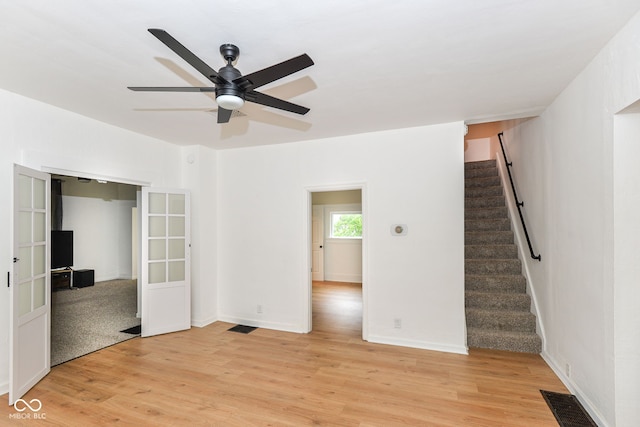 201 N 11th St, Elwood, IN 46036 - unfurnished room featuring stairs, ceiling fan, light wood finished floors, and baseboards