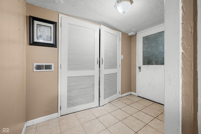242 W Warford Dr, Princes Lakes, IN 46164 - corridor with a textured ceiling, baseboards, and light tile patterned flooring