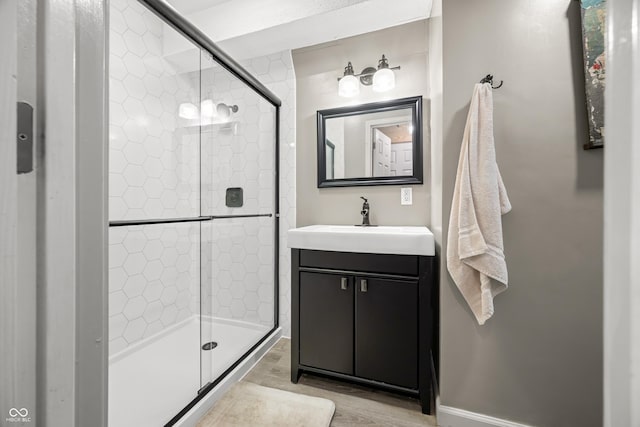 242 W Warford Dr, Princes Lakes, IN 46164 - bathroom with wood finished floors, a shower stall, vanity, and baseboards