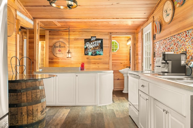 242 W Warford Dr, Princes Lakes, IN 46164 - kitchen with wooden ceiling, light wood finished floors, wooden walls, white cabinetry, and a sink