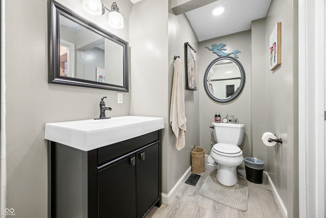 242 W Warford Dr, Princes Lakes, IN 46164 - bathroom featuring baseboards, wood finished floors, toilet, and vanity