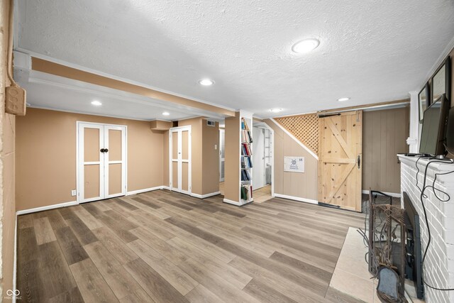 242 W Warford Dr, Princes Lakes, IN 46164 - unfurnished living room featuring a textured ceiling, wood finished floors, baseboards, french doors, and recessed lighting