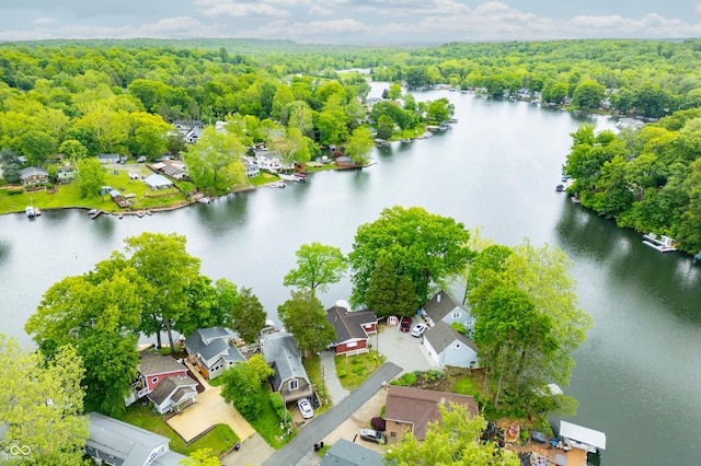 242 W Warford Dr, Princes Lakes, IN 46164 - aerial view of residential area featuring a heavily wooded area and a nearby body of water
