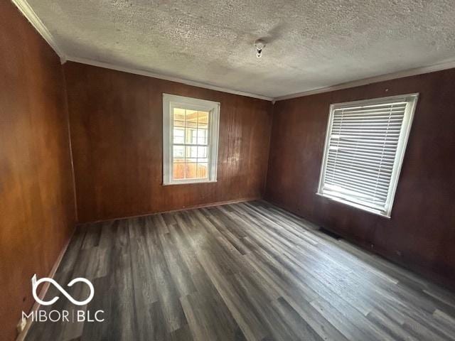 1527 Main St, Beech Grove, IN 46107 - spare room with wood finished floors, ornamental molding, a textured ceiling, and wood walls