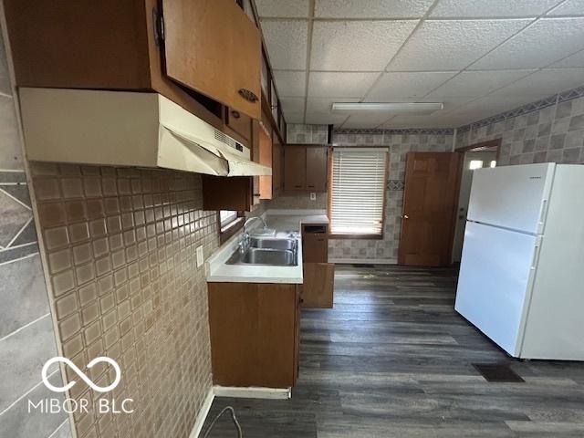 1527 Main St, Beech Grove, IN 46107 - kitchen featuring freestanding refrigerator, a sink, light countertops, dark wood-type flooring, and a paneled ceiling
