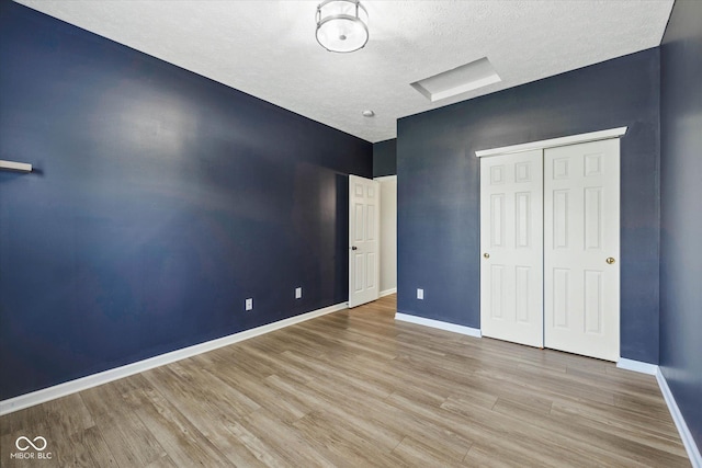 1854 Oconnor Ct, Avon, IN 46123 - unfurnished bedroom featuring wood finished floors, a closet, and a textured ceiling