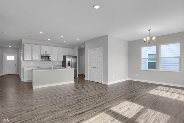 633 Bridgeman Rd, Avon, IN 46123 - kitchen with stainless steel appliances, dark wood finished floors, open floor plan, a chandelier, and white cabinetry