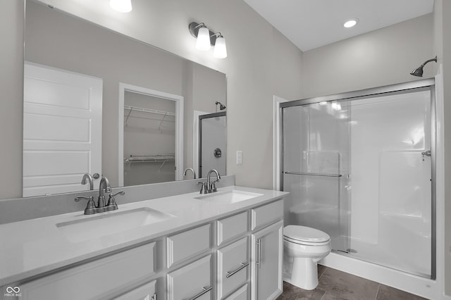 633 Bridgeman Rd, Avon, IN 46123 - bathroom featuring a shower stall, toilet, double vanity, and a walk in closet
