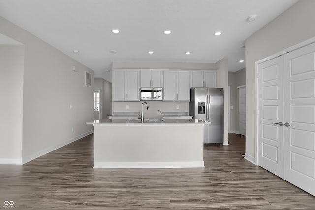 633 Bridgeman Rd, Avon, IN 46123 - kitchen featuring appliances with stainless steel finishes, an island with sink, white cabinetry, a sink, and light countertops