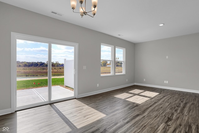 633 Bridgeman Rd, Avon, IN 46123 - spare room featuring a chandelier, dark wood finished floors, baseboards, a water view, and recessed lighting