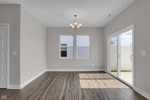 633 Bridgeman Rd, Avon, IN 46123 - unfurnished dining area with a chandelier, dark wood-style flooring, and baseboards