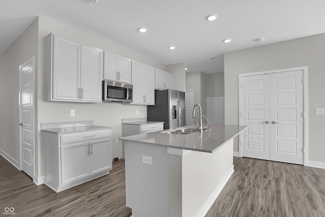 633 Bridgeman Rd, Avon, IN 46123 - kitchen featuring appliances with stainless steel finishes, wood finished floors, white cabinets, a sink, and recessed lighting