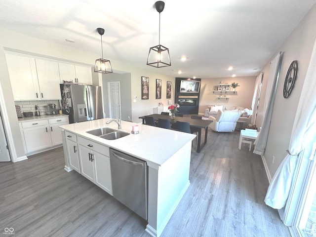 1056 Bent Branch Ln, Greenwood, IN 46143 - kitchen with stainless steel appliances, a sink, open floor plan, wood finished floors, and recessed lighting