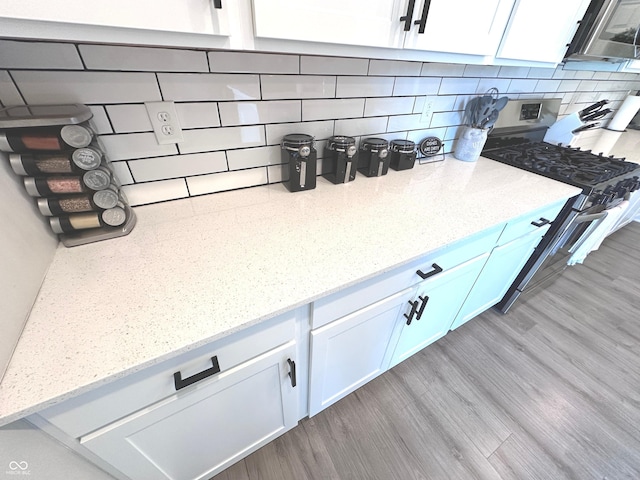 1056 Bent Branch Ln, Greenwood, IN 46143 - kitchen view of stainless steel appliances, white cabinets, decorative backsplash, and light stone counters