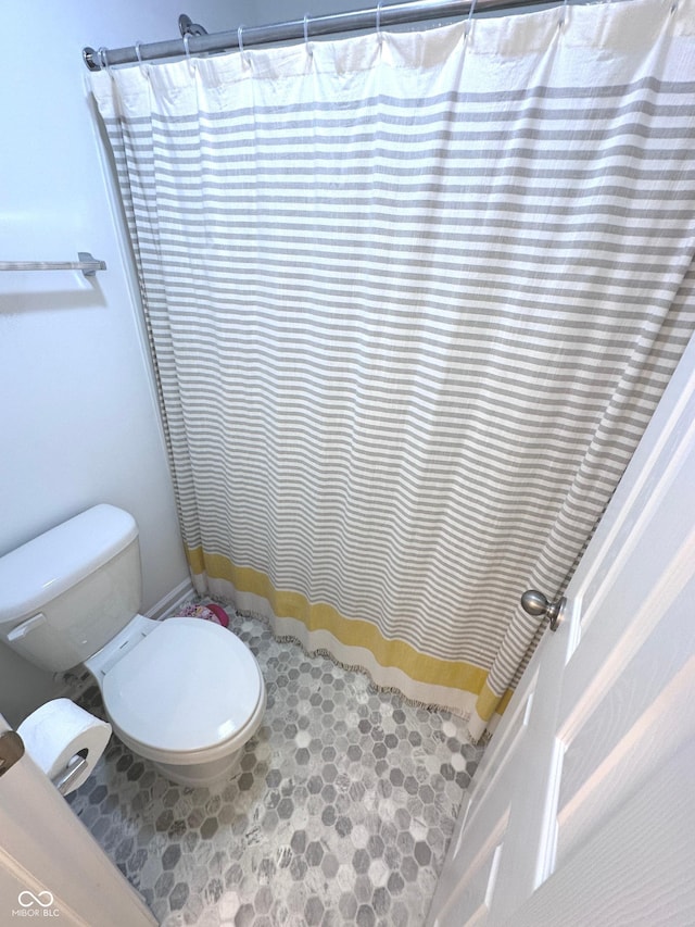1056 Bent Branch Ln, Greenwood, IN 46143 - bathroom with toilet, a shower with shower curtain, and tile patterned floors