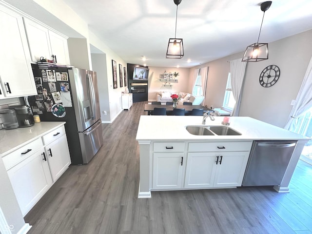 1056 Bent Branch Ln, Greenwood, IN 46143 - kitchen featuring appliances with stainless steel finishes, open floor plan, wood finished floors, an island with sink, and a sink
