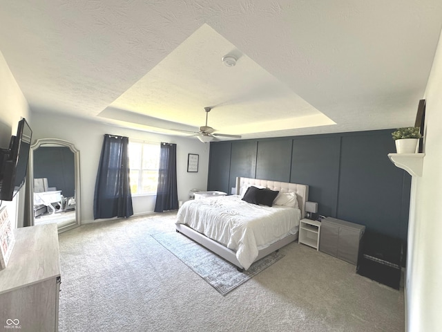 1056 Bent Branch Ln, Greenwood, IN 46143 - bedroom with a raised ceiling, carpet, ceiling fan, and a textured ceiling